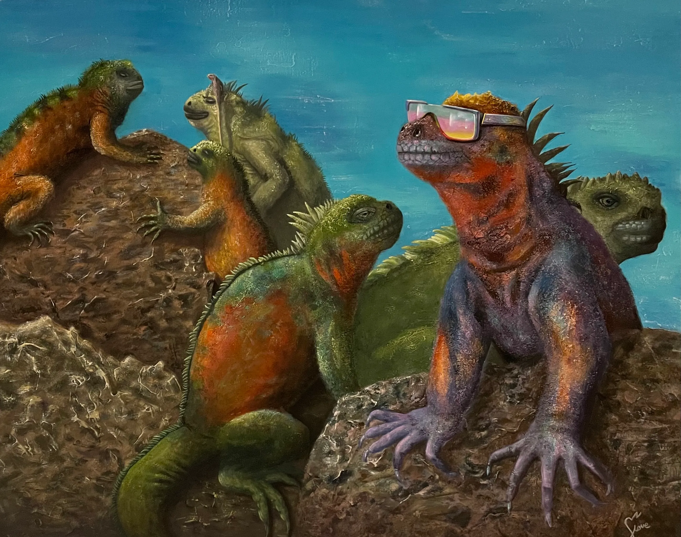 A group of iguanas on rocky ground beneath a blue sky.