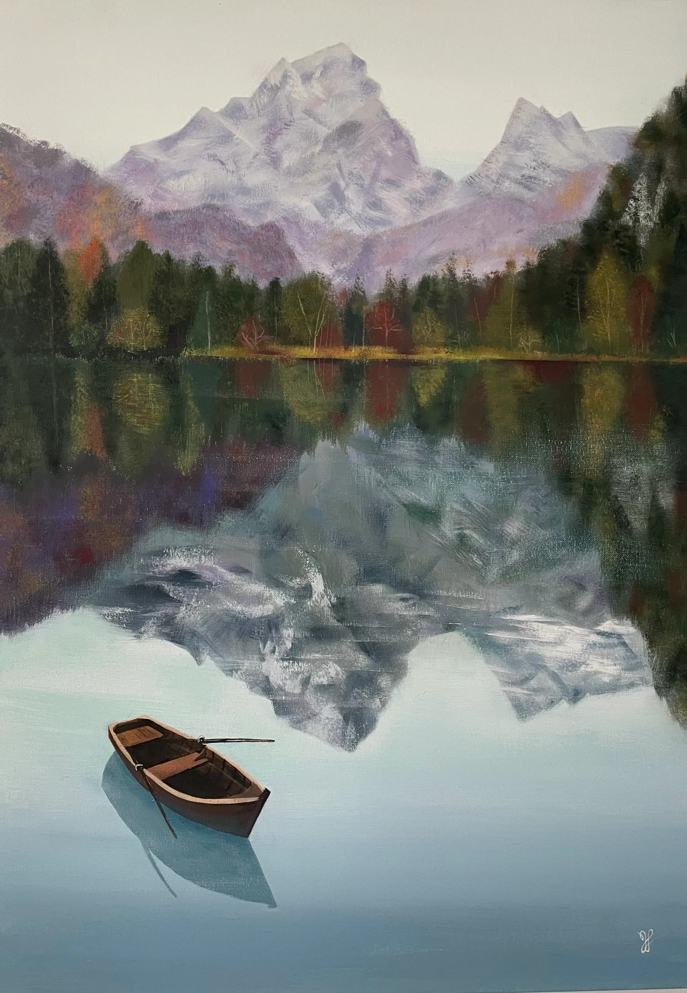 A boat on a lake reflecting forest and mountain peaks.