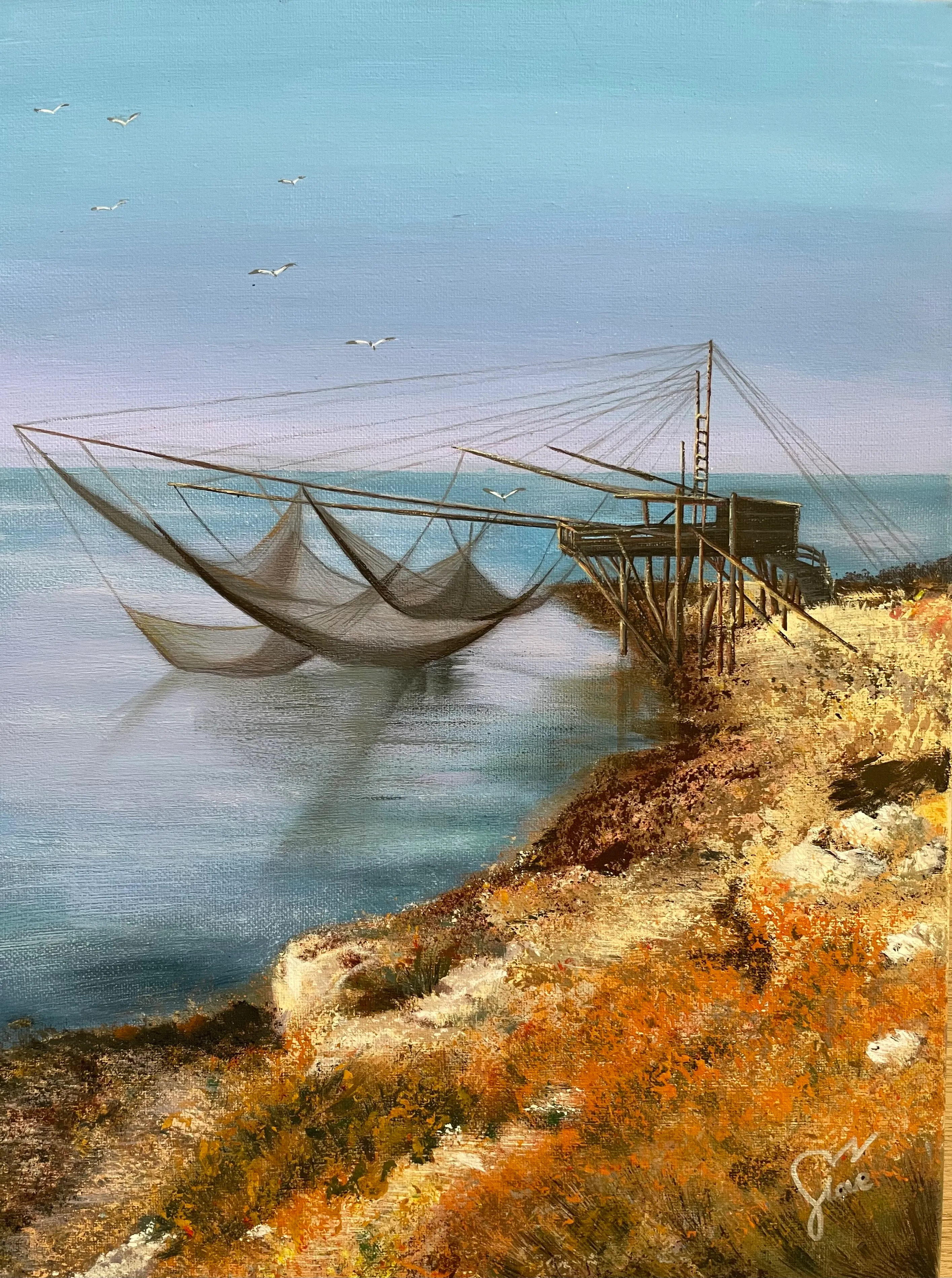 A traditional fishing structure on a rocky coast above calm water.
